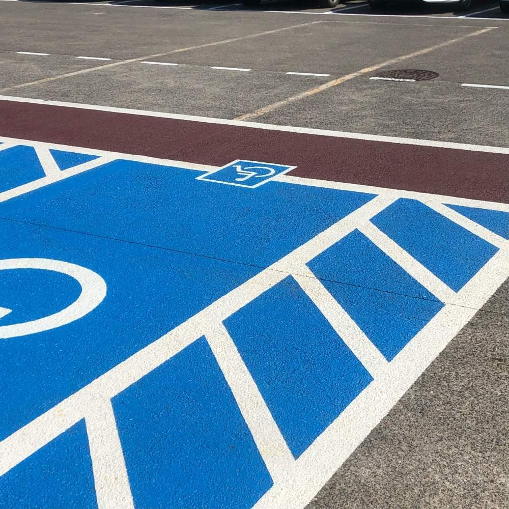 ADA-compliant accessible parking space with blue striping and the international symbol of accessibility